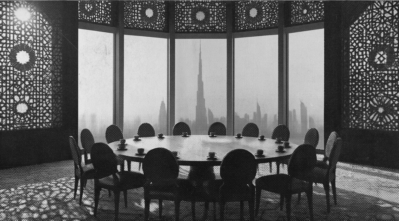 A round table set for a dozen, chairs pulled in, the Dubai skyline through the window behind it.